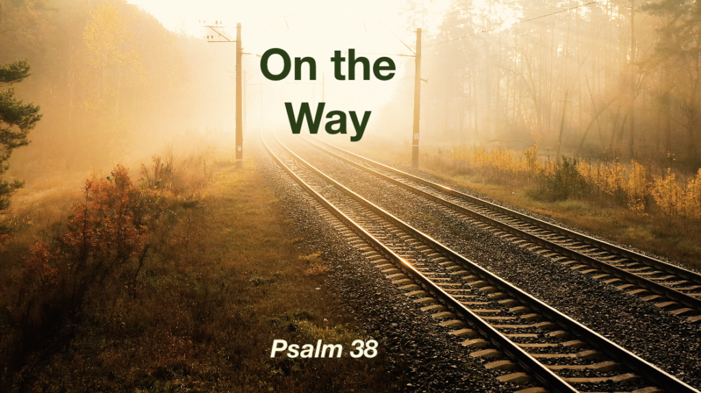Empty train tracks disappearing into golden fog with the text "On The Way - Psalm 38"