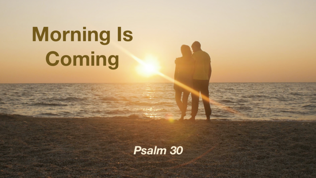 Couple standing on shoreline watching a sunrise with the text "Morning Is Coming - Psalm 30"